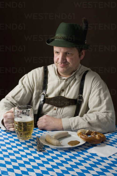 stereotypical-german-man-in-bavarian-costume-with-a-beer-and-german-meal-FSIF02547.jpg