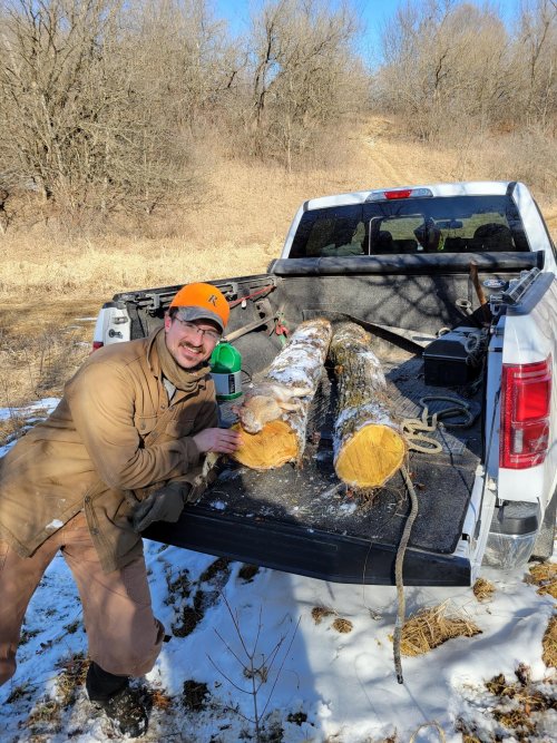 20220226 David Delaney with rabbit and 2 chunks of Osage Orange for long bows.jpg