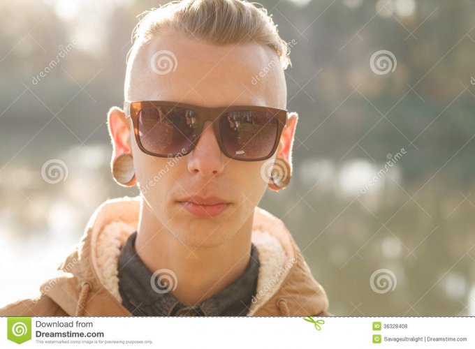 guy-plugs-close-up-portrait-ear-sunglasses-looking-camera-36328408.jpg