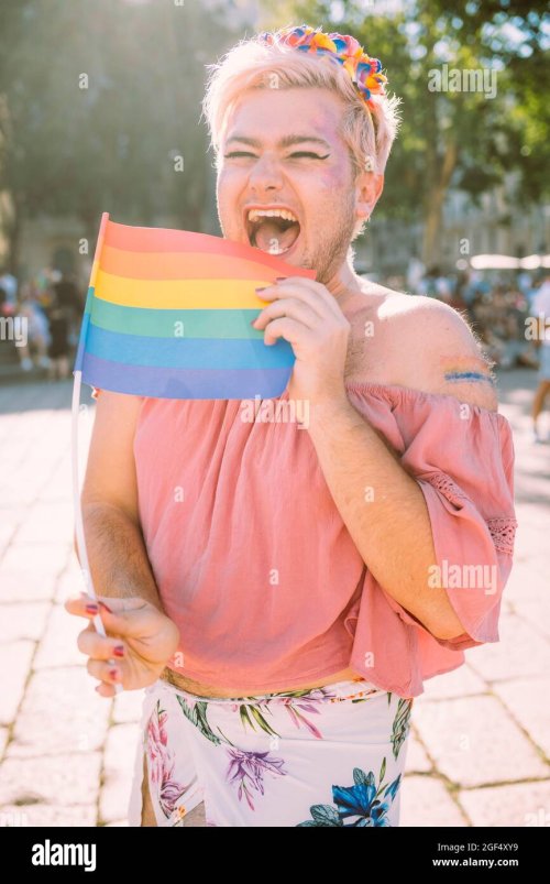 happy-gay-man-laughing-with-rainbow-flag-on-sunny-day-2GF4XY9.jpg