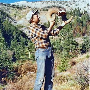 Showing off horns from my 8 1/2-year old ram which grossed 174+".  The hillside I got him on in the background.