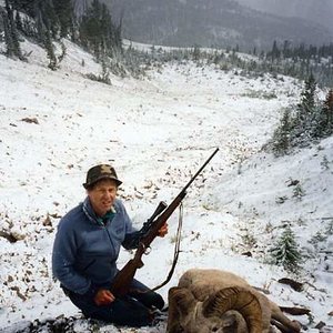 Friend Tom, with his Bighorn Ram where it fell in the Sun River country of Montana.