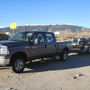 My Old rig towing my jeep with the Rockies in the background!