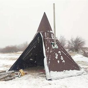 Hot tent camping with a burning wood stove in snow.jpg