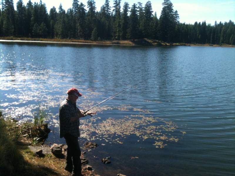 Dad taking a break from hunting , looking for a trout