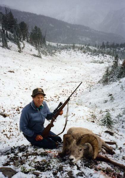 Friend Tom, with his Bighorn Ram where it fell in the Sun River country of Montana.