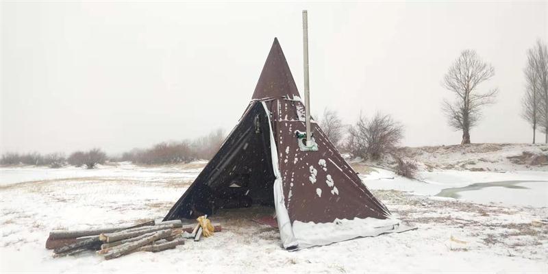 Hot tent camping with a burning wood stove in snow.jpg