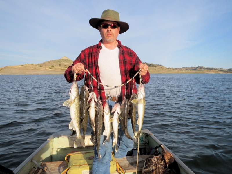 Me with some walleye and a bass from our first day out this year