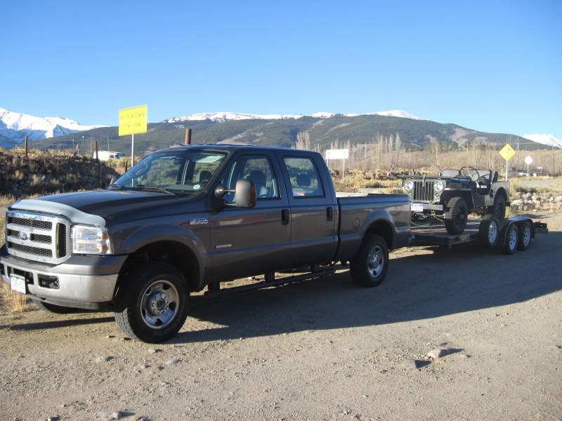 My Old rig towing my jeep with the Rockies in the background!