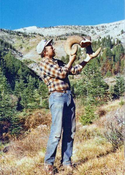 Showing off horns from my 8 1/2-year old ram which grossed 174+&quot;.  The hillside I got him on in the background.
